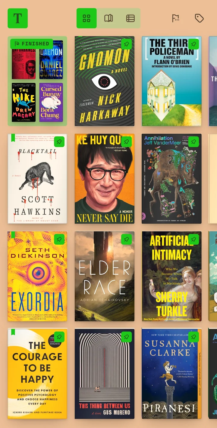 The shelf on a phone: three columns of covers, pins and a finished badge.