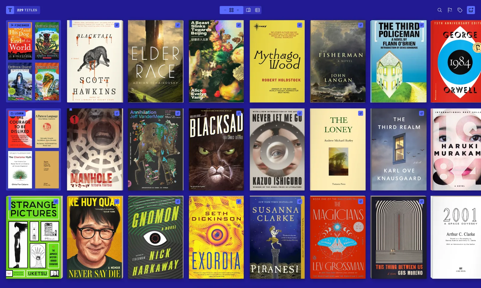 Tomen’s shelf in the Pigment theme with the Indigo accent: 229 titles as their real covers, the finished ones and a collection each stacked into one tile, pins on many.